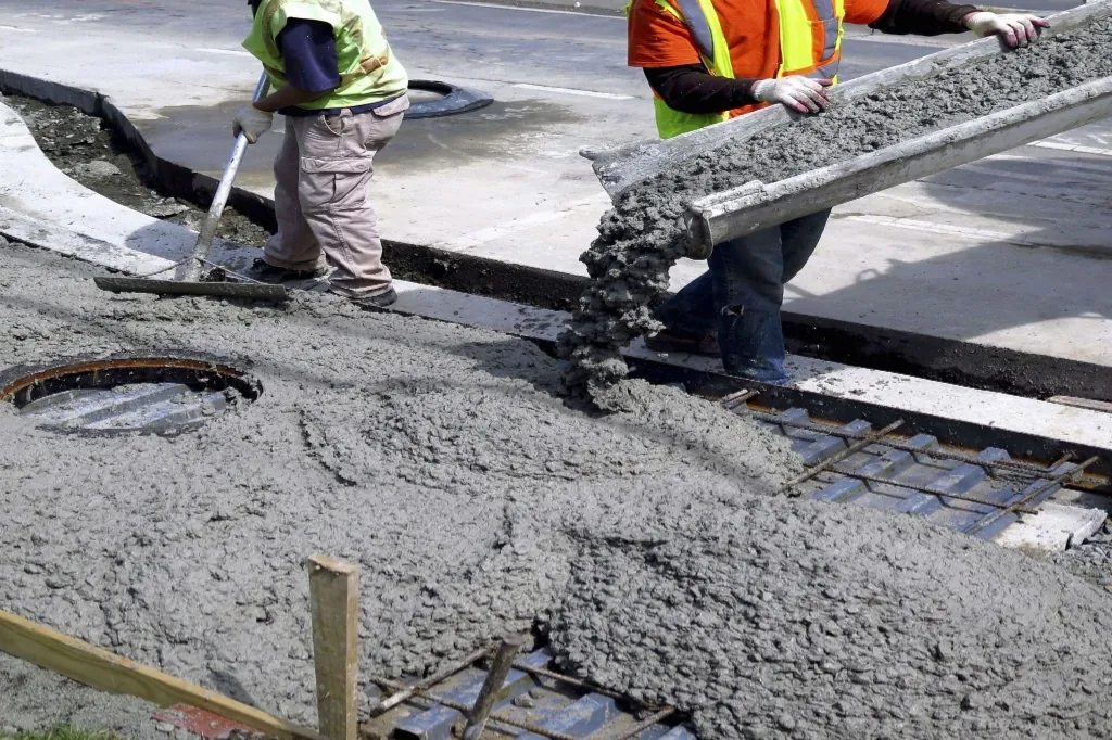 Liquid concrete admixture being dosed into fresh concrete pour