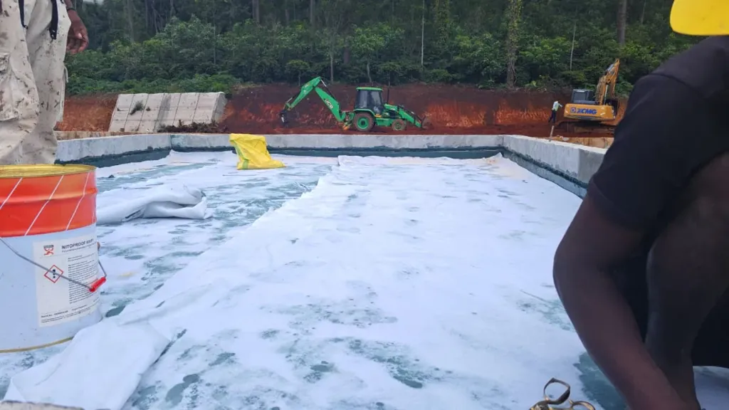 Fabric-reinforced polyurethane waterproofing membrane laid across a terrace slab